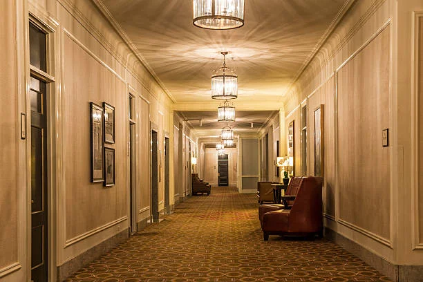 a hotel hallway / gets from the elevator / over to your room